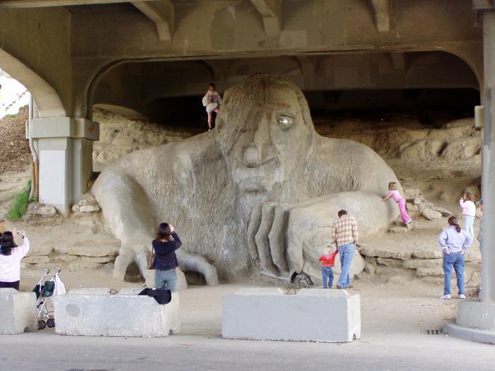 people photographing and climbing on the Fremont Troll