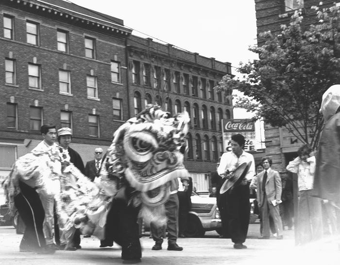 Black and white photo of Chinese dragon dance at Hing Hay Park in Seattle, 1975