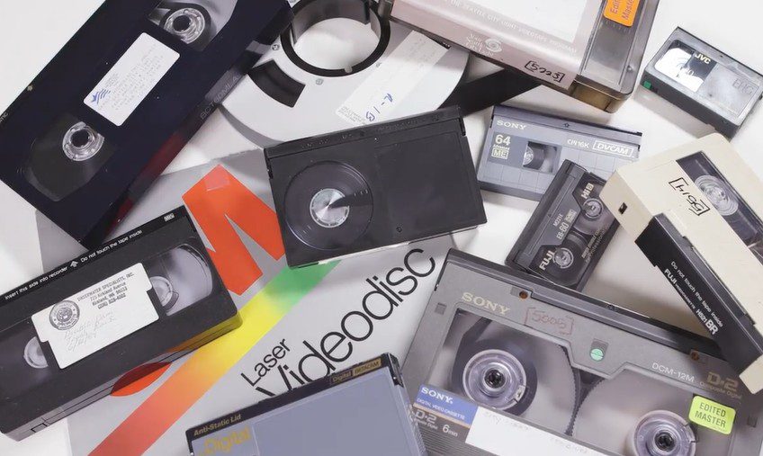 color photo of a pile of various obsolete magnetic media tapes
