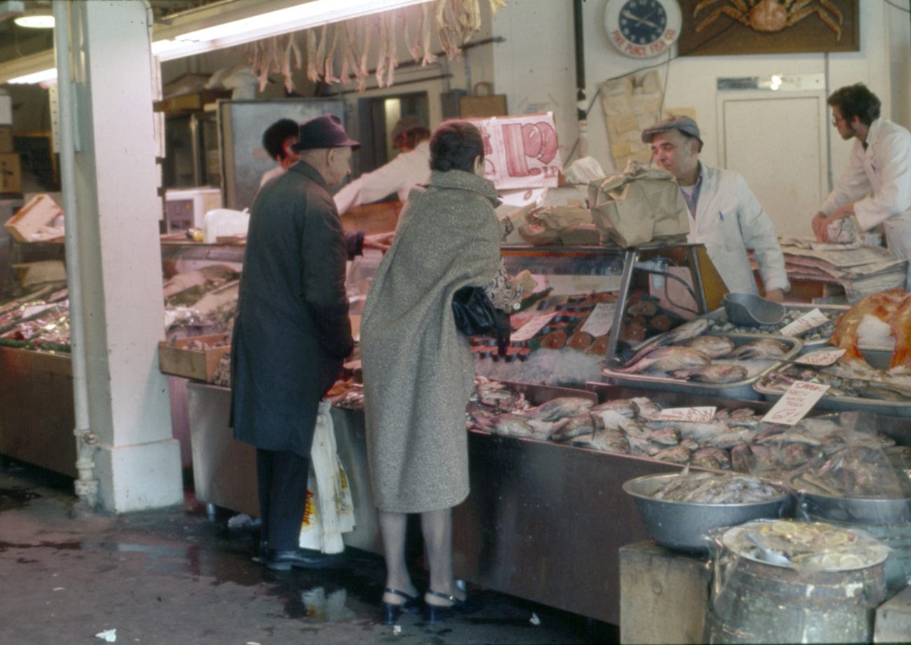 color photo of Pike Place Market fish vendor and customers circa 1975