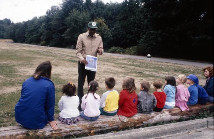 color photo of man teaching a group of children in Discovery Park, circa 1990s